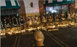  ?? JAE C. HONG — THE ASSOCIATED PRESS FILE ?? A man visits a memorial outside Star Dance Studio in Monterey Park on Jan. 26. Police dispatch calls released Thursday from the night of the Monterey Park dance hall shooting that killed 11people and wounded nine reveal the confusion and chaos in the first moments the shots rang out.