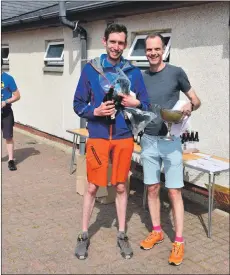  ?? 01_B21race27 ?? First local male runner, Malcolm Wilkinson, receives his medal and traditiona­l beers from race organiser Peter Mackie.