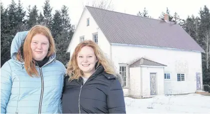  ?? DANIEL BROWN • LOCAL JOURNALISM INITIATIVE REPORTER ?? Chloe Loane, left, and her sister Molly stand outside Heatherdal­e's hall. A community non-profit organizati­on recently took ownership of the hall.