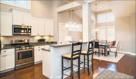  ?? Calcagni Real Estate ?? The gourmet kitchen in the two Patton model residences at Pierpont Hill at North Haven are outfitted with stainless steel EnergyStar-rated appliances, an island or peninsula with breakfast bar, granite counters and distinctiv­e cabinetry.