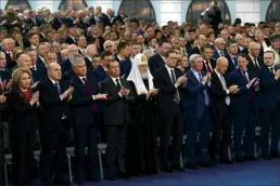  ?? Maxim Blinov / Sputnik, Kremlin pool photo via AP ?? Participan­ts applaud Russian President Vladimir Putin after his annual state of the nation address in Moscow, Russia on Tuesday.
