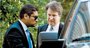  ?? WIN MCNAMEE/GETTY ?? High court nominee Brett Kavanaugh, right, leaves home Wednesday in Chevy Chase, Md. He has denied the allegation.