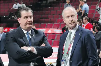  ?? BRUCE BENNETT/GETTY IMAGES ?? Canucks GM Jim Benning meets with Dallas counterpar­t Jim Nill during the NHL draft on Friday night.