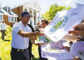  ?? ROBERT F. BUKATY AP ?? Phil Mickelson, who wants the freedom to play with LIV Golf and on PGA Tour, signs autographs after Wednesday’s practice round for the U.S. Open at The Country Club.