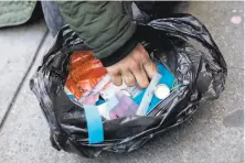  ?? Jessica Christian / The Chronicle 2020 ?? A homeless woman named Courtney sifts through her bag of fentanyl smoking parapherna­lia on Turk Street in S.F.