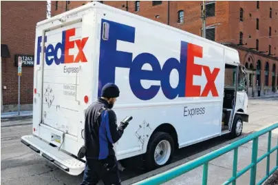  ?? ASSOCIATED PRESS FILE PHOTO ?? A FedEx driver returns to his truck in downtown Pittsburgh. FedEx says it will give wage increases, bonuses and make a voluntary $1.5 billion contributi­on to its pension plan following recent tax reform legislatio­n. The company also will invest $1.5...