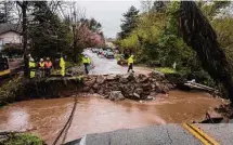  ?? Nic Coury/Associated Press ?? Crews assess damage from a storm that washed out North Main Street on Friday in Soquel, Calif.
