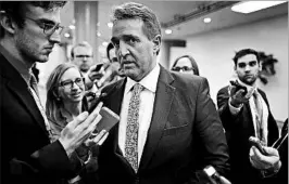  ?? CHIP SOMODEVILL­A/GETTY ?? Sen. Jeff Flake, R-Ariz., speaks with reporters Thursday about the tax-cut bill, which is still being revised by GOP leaders.