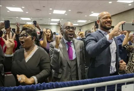  ?? Evan Vucci/Associated Press ?? Supporters of President Donald Trump cheer Friday as he arrives to speak during the launch of “Black Voices for Trump” at the Georgia World Congress Center in Atlanta.