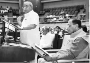  ?? PHOTO: PTI ?? Gujarat Deputy Chief Minister and Finance Minister Nitin Patel presents the State Budget 2018-19 in the Assembly in Gandhinaga­r on Tuesday