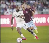  ?? Associated Press ?? Los Angeles FC defender Sebastien Ibeagha (front) pursues the ball ahead of Colorado Rapids forward Diego Rubio in the first half on Sunday in Commerce City, Colo. The Rapids won 5-2.