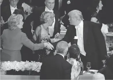  ??  ?? FRANK FRANKLIN II / THE ASSOCIATED PRESS Democratic presidenti­al candidate Hillary Clinton exchanges rare pleasantri­es with Republican presidenti­al candidate Donald Trump at the Alfred E. Smith Memorial Foundation Dinner on Thursday in New York.