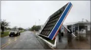  ?? ROGELIO V. SOLIS — THE ASSOCIATED PRESS ?? A vehicle passes a toppled gas pump canopy in Berwick, La., following a severe weather assault from Tropical Storm Barry, Saturday.