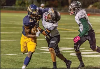  ?? Cory Rubin/The Signal (See additional photos on signalscv.com) ?? Cougars sophomore wide receiver Jarrin Pierce stiff-arms a Huskies defender in a win over East LA College at College of the Canyons on Saturday night. The Cougars defeated the Huskies 31-9.