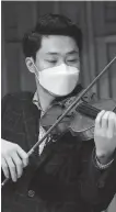  ?? HUO YAN / CHINA DAILY ?? Zhou Huyi from the Xi’an Symphony Orchestra attends a rehearsal.