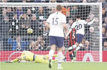  ?? — AFP photos ?? 20 To enham Hotspur’s English midfielder Dele Alli (right) scores his team’s second goal past Bournemout­h’s English goalkeeper Aaron Ramsdale during the English Premier League football match between To enham Hotspur and Bournemout­h at the To enham Hotspur Stadium in London.