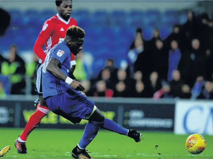  ??  ?? > Omar Bogle guides home Cardiff City’s second against Ipswich last night (main image) and below left, Bogle is mobbed. Below right, Junior Hoilett savours the Cardiff opener