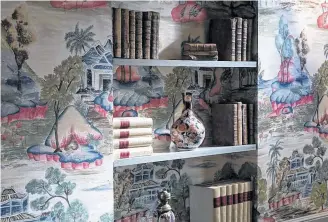  ??  ?? Period style wallpaper continues behind the shelves to liven displays of books and antiques.