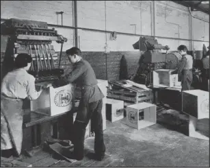  ??  ?? Workers in the crating department, above and left. Right, Tennent’s vans in the loading area, around 1950