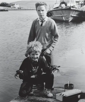  ??  ?? Cormac and Gerry Flannery, Goat Street, Dingle, fishing for crabs at Dingle PIer on Friday.