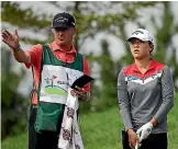  ??  ?? Caddie Jason Hamilton gives advice to Lydia Ko during their final tournament together in Korea.