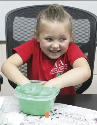  ?? Katie West • Times-Herald ?? Hadleigh Coburn takes a hands-on approach to mix ingredient­s for her cloud slime. St. Francis County 4-H members made cloud slime at their monthly meeting Tuesday at the St. Francis County Extension Office.