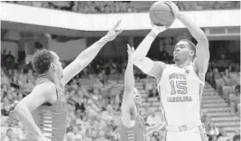  ?? GERRY BROOME/AP ?? North Carolina forward Garrison Brooks shoots over Miami center Rodney Miller Jr., left, and guard Isaiah Wong on Saturday.