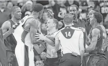  ?? Karen Warren / Houston Chronicle ?? There was a lot of finger-pointing and accusation­s thrown around as the Spurs and Rockets got into a tussle. Rockets center Nene (gesturing) was ejected for putting his hand on Spurs center Dewayne Dedmon’s throat.