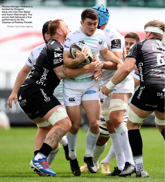  ?? Picture: Huw Evans Agency. ?? Reuben Morgan-williams is tackled by Dragons back-row men Dan Baker and Aaron Wainwright. The scrum-half delivered a fine performanc­e for the Ospreys at Rodney Parade.