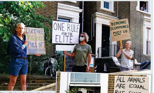  ??  ?? Signs of the times: Protesters with placards outside Dominic Cummings’ home yesterday