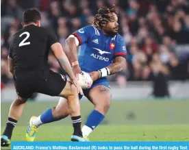  ??  ?? AUCKLAND: France’s Mathieu Bastareaud (R) looks to pass the ball during the first rugby Test match between the New Zealand All Blacks and France at Eden Park in Auckland.— AFP