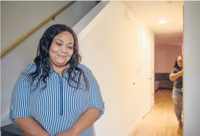  ?? MARK MIRKO /HARTFORD COURANT ?? Village at Park River resident Jodiann James, left, and her daughter Ajahnee Phillips stand inside their new apartment. James lived in the old Westbrook Village and returned to the redevelope­d property last fall after a two-year relocation.