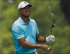  ?? DARRON CUMMINGS — THE ASSOCIATED PRESS ?? Tiger Woods, watching his shot Thursday at the third tee, shot a 1-under 71 in his first tournament since golf returned from the pandemic shutdown.