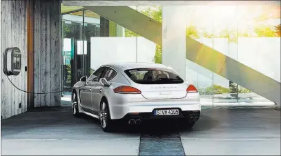  ?? COURTESY PORSCHE ?? A Porsche Panamera S E-Hybrid is plugged into an SAE J1772 AC Level 2 charging station.