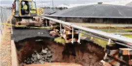  ?? CAA/Contribute­d photo ?? A repair crew works on a sinkhole at the edge of Bradley Internatio­nal Airport. The sink hole formed due to a failed storm pipe away from runways.