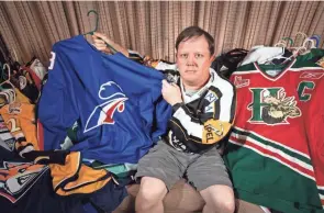  ?? ?? Chaffin shows off his collection of jerseys. His Twitter account has roughly 4,500 followers, including players, their families and journalist­s who have at times quoted Chaffin because of his expertise.