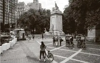  ?? Karsten Moran / New York Times ?? Pedestrian­s and cyclists are shown early this month in New York City’s Central Park. The coronaviru­s recently has seeped through both urban and rural communitie­s.