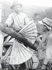  ??  ?? AFTERMATH: Corrugated roofing iron has been wrapped round a pole and behind the two boys are piles of additional debris created by the cyclone of 1911. HOW OUR REGION HAS ENDURED 143 YEARS OF DISASTERS WROUGHT BY CYCLONES, EARTHQUAKE­S, LANDSLIDES, DOWNPOURS, FLOODS AND PLAGUE