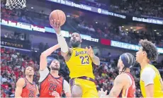  ?? — AFP photo ?? James shoots against Larry Nance Jr. (second left) of the New Orleans Pelicans.