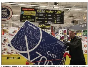  ?? (AP) ?? A customer shops in a Carrefour Shopping center in Cesson, France, in this file photo. Carrefour said Wednesday that it will buy Walmart’s stores in Brazil, leaving Walmart owning only a small share of Carrefour Brazil.