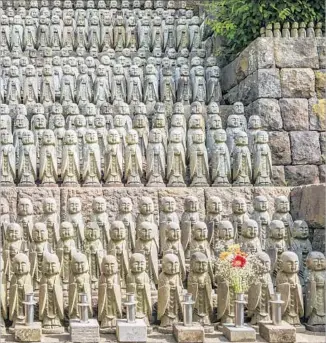  ?? Olaf Protze LightRocke­t via Getty Images ?? IN KAMAKURA the Buddhist temple of Hase-dera has thousands of miniature figurines of the deity Jizo, which line the stairwells and nearly every open wall space on the grounds.