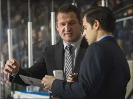  ?? MARISSA BAECKER/Shootthebr­eeze.ca ?? Kelowna Rockets head coach Adam Foote, left, talks strategy with assistant coach Travis Crickard during Friday’s victory over the Victoria Royals. The Rockets improved to 10-5-2-0 under Foote since he replaced Jason Smith in a coaching change on Oct. 23.