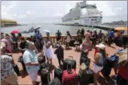  ?? GERALD HERBERT — THE ASSOCIATED PRESS FILE ?? In a file photo, people evacuating Puerto Rico line up to get on a cruise ship in the aftermath of Hurricane Maria, in San Juan, Puerto Rico.