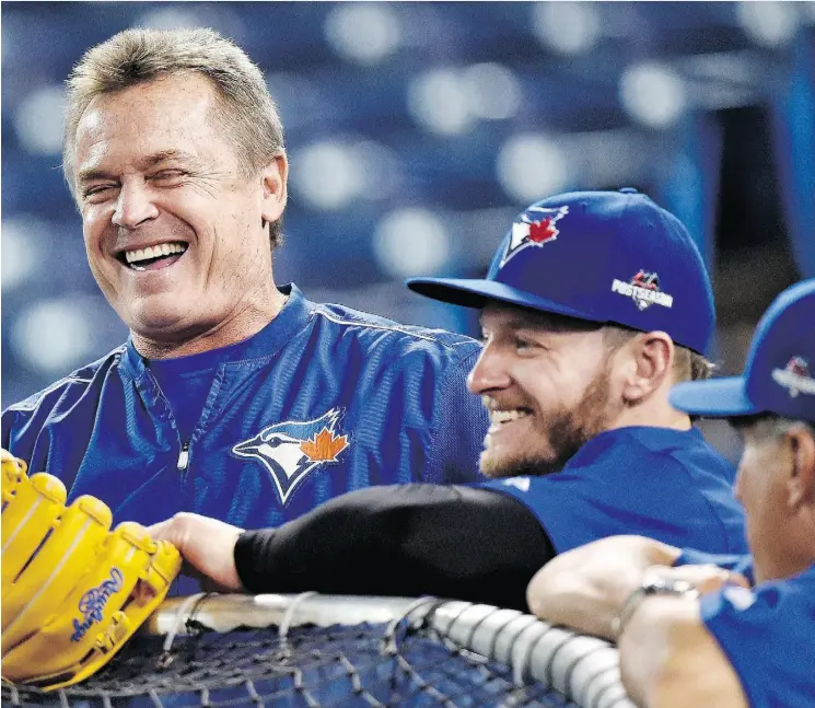  ?? NATHAN DENETTE/THE CANADIAN PRESS ?? Blue Jays manager John Gibbons, left, and third baseman Josh Donaldson share a happy moment during a practice Tuesday in Toronto.