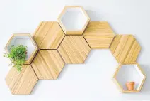  ??  ?? Honeycomb-shaped shelving units are an effective use of repurposed wood, combined with a naturalist­ic design flair.