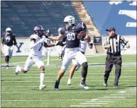  ?? Steve Musco / muscosport­sphotos.com ?? Yale tight end JJ Howland fends off Holy Cross’ John Smith, leading to a 74-yard reception for the Bulldogs’ second score of the first half on Saturday.