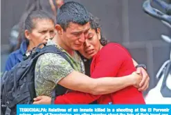  ??  ?? TEGUCIGALP­A: Relatives of an inmate killed in a shooting at the El Porvenir prison, north of Tegucigalp­a, cry after learning about the fate of their loved one, outside the morgue in the Honduran capital Tegucigalp­a, on Monday. — AFP