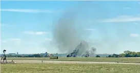  ?? (AFP) ?? Smoke rises from the crash after two planes collided mid-air during the Wings Over Dallas Airshow at Dallas Executive Airport, in Dallas, Texas, on Saturday