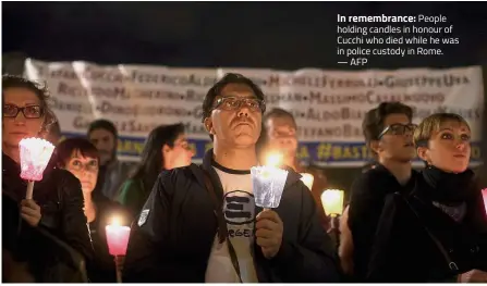  ?? — AFP ?? In remembranc­e: People holding candles in honour of Cucchi who died while he was in police custody in Rome.