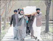  ?? REUTERS FILE ?? Afghan Sikh men carrying a coffin of one of the victims who was killed in the attack, in Kabul, Afghanista­n.